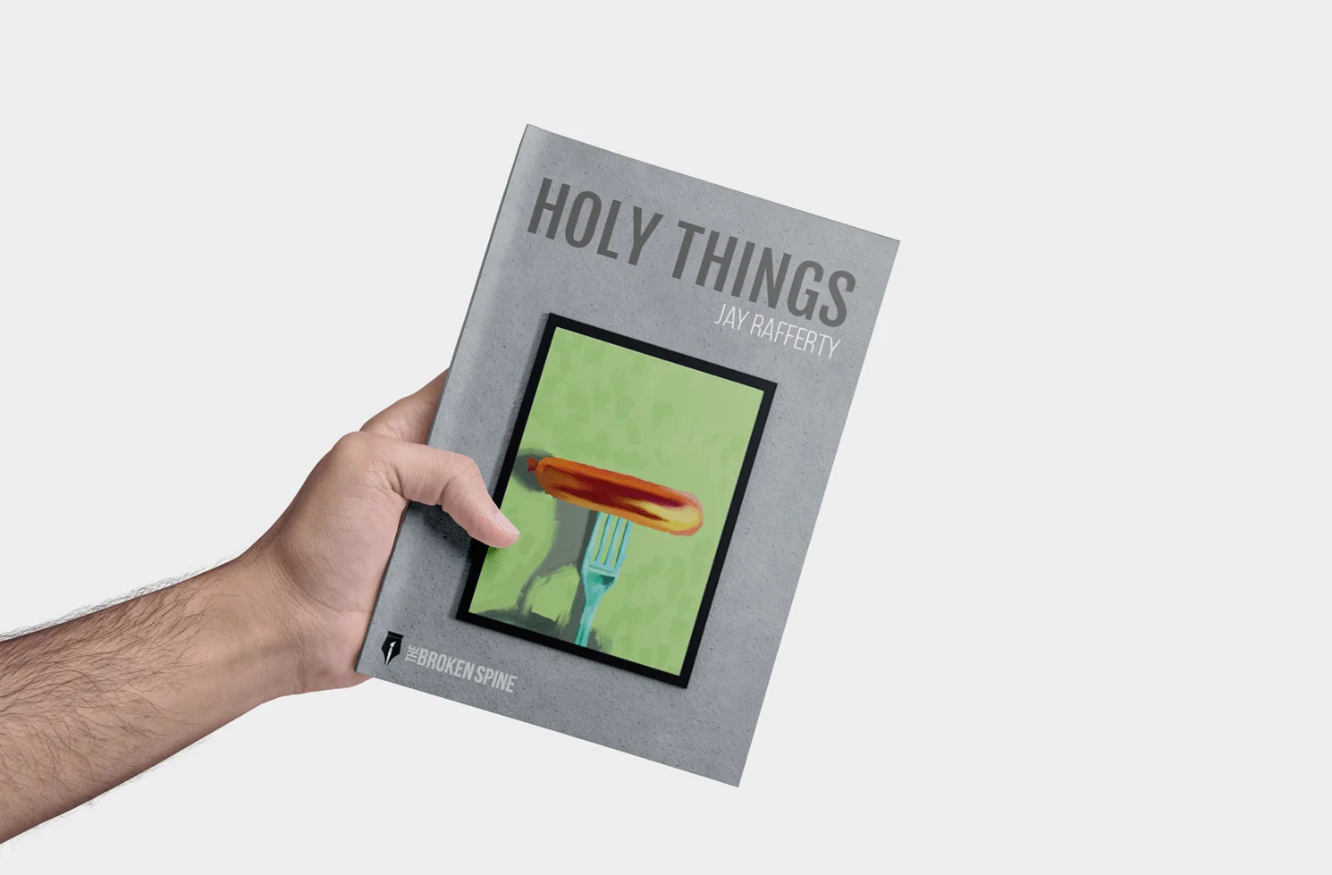 Print edition of Holy Things by Jay Rafferty held in a hand