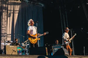 Paul Weller and Steve Craddock playing guitars on stage at Lytham Festival 2022