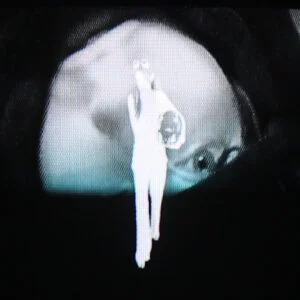 Waterbaby's Thin Air artwork: a white figure projected on a face