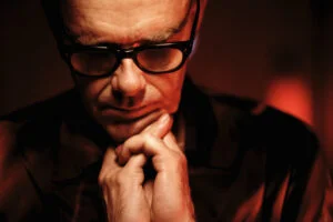 Leftfield's Neil Barnes, chin resting on his hands, photo by Steve Gullick