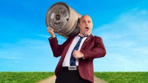 Al Murray as the Pub Landlord carrying a beer keg