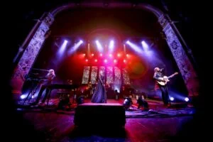 Rumours of Fleetwood Mac on a red and purple-lit stage