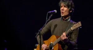 Edgar Jones singing and playing acoustic guitar