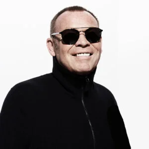 Ali Campbell in sunglasses and a black zip-up top