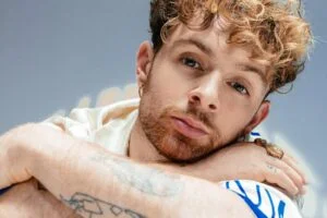 Tom Grennan resting his head on his arm