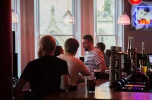 Audience members at the bar at Broken Spine Live