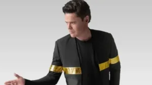 Donny Osmond in a black jacket with gold armbands