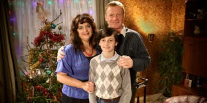 A Child's Christmas in Wales: a family posing by a Christmas tree