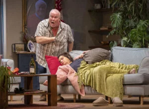 Two actors in a living-room set in Haunted Scouse at the Royal Court, photo by Jason Roberts