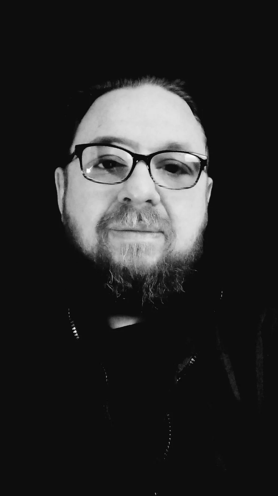 Alan Parry, Editor-in-Chief of The Broken Spine, a bearded man in glasses, in black and white