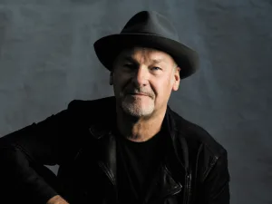 Paul Carrack in a black hat and leather jacket
