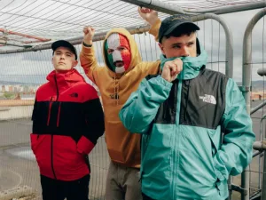 The three members of Kneecap, one in a tricolour balaclava