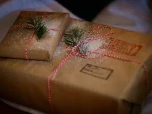 A brown-paper parcel tied with string and a sprig of pine