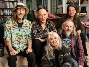 Hawkwind, six band members, posing in a book-lined room