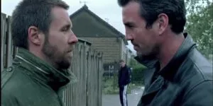 Still from Dead Man's Shoes: two men face each other on a quiet street