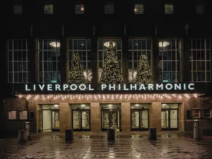 Liverpool Philharmonic Hall entrance at night with Christmas trees
