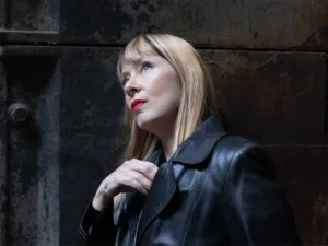 Suzanne Vega in a black leather coat