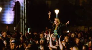 A fan held aloft in the crowd at Sting on the Waterfront, Pier Head, photo by Anthony Mooney