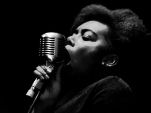 Black-and-white image of a singer at a vintage microphone