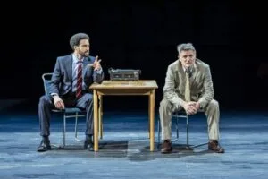 Two actors seated at a table with a tape recorder in Inspector Morse at Liverpool Playhouse