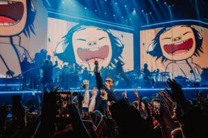 Gorillaz on stage in Liverpool with giant cartoon characters on screen, photo by Luke Dyson