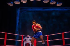 An actor in red boxing gloves in the ring in Conteh at the Royal Court